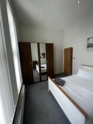 a bedroom with a large bed and a mirror at No 3 - LARGE 1 BED NEAR SEFTON PARK AND LARK LANE in Liverpool