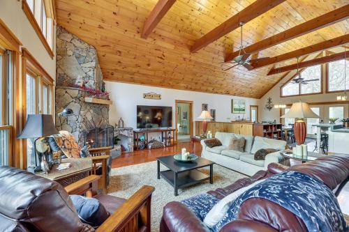 a large living room with a stone wall at Cabin with Hot Tub and WiFi 4 Mi to Snowshoe Resort in Cass