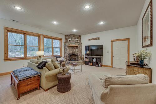 a living room with a couch and a fireplace at Cabin with Hot Tub and WiFi 4 Mi to Snowshoe Resort in Cass