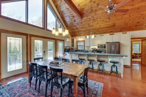 a large kitchen with a wooden table and chairs at Cabin with Hot Tub and WiFi 4 Mi to Snowshoe Resort in Cass