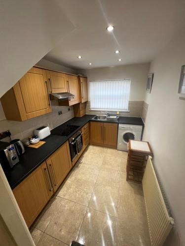 an overhead view of a kitchen with wooden cabinets at No 3 - LARGE 1 BED NEAR SEFTON PARK AND LARK LANE in Liverpool