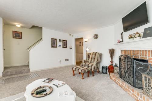 a living room with a fireplace and a tv at Georgia Townhome - 3 Mi to Stone Mountain Park! in Stone Mountain