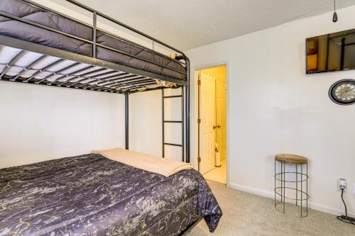 a bedroom with a bunk bed and a clock on the wall at Georgia Townhome - 3 Mi to Stone Mountain Park! in Stone Mountain