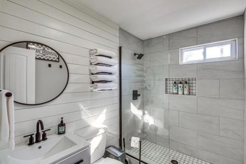 a white bathroom with a sink and a mirror at Modern and Stylish Olathe Home in Prime Location in Olathe