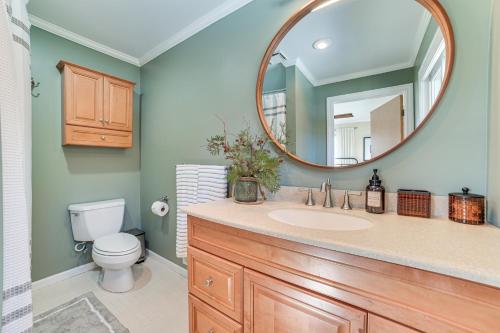 a bathroom with a sink and a mirror at Riverfront Cheboygan Home with Deck and Boat Dock! in Cheboygan