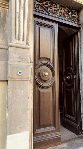 a wooden door on the side of a building at Palazzo Lucangeli in Porto Recanati