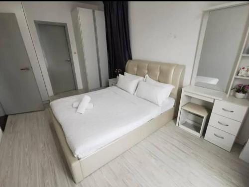 a bedroom with a white bed and a mirror at Dreamland in Kota Kinabalu