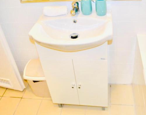 a bathroom with a white sink and a toilet at Serendipity 3 in Pécs