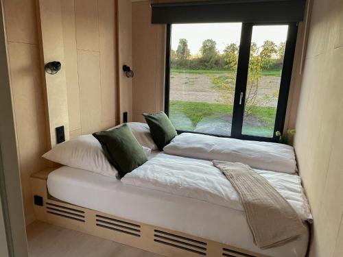 a couple of beds in a small room with a window at Nordic Thor in Belau