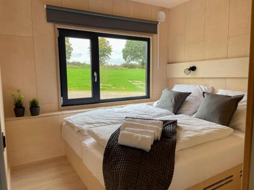 a large bed in a room with a window at Nordic Loki in Belau