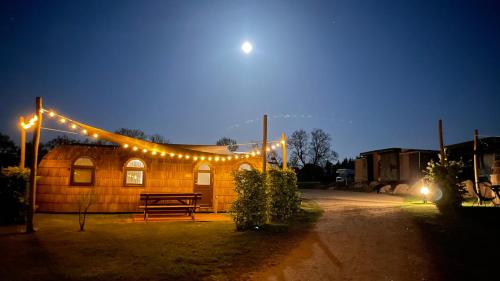 a wooden building with lights on it at night at Tiny Igloo Johansson in Belau