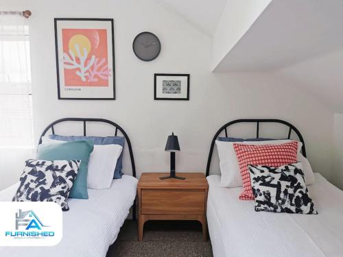 two beds sitting next to each other in a bedroom at 4 Bedroom House - Contractors Welcome in Scarborough