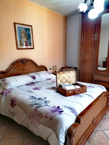 a bedroom with a bed with a suitcase on it at La casa di Pina in Latronico