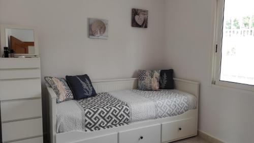 1 dormitorio con cama con almohadas y ventana en Apartamento Vista Magnifica, en Castillo del Reboller