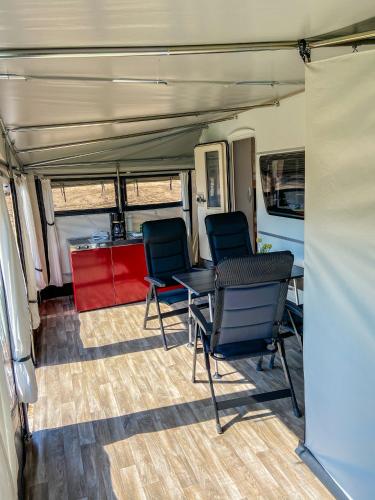 a table and chairs sitting in a trailer at George Glamper KÜSTENKIND in Belau