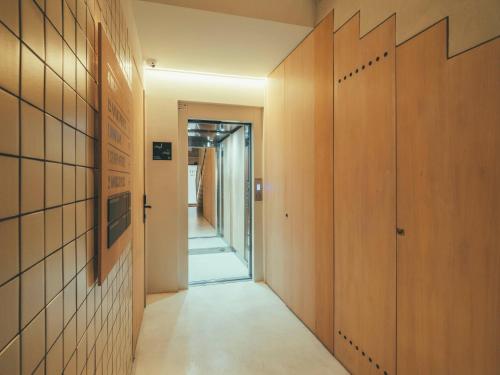 a hallway with wooden doors and a hallway leading into a room at Boutique Apartments 23 Barcelona in Barcelona
