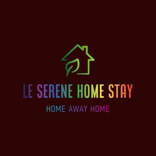 a green home stay sign with a house arrow at Le Serene in Meenangadi