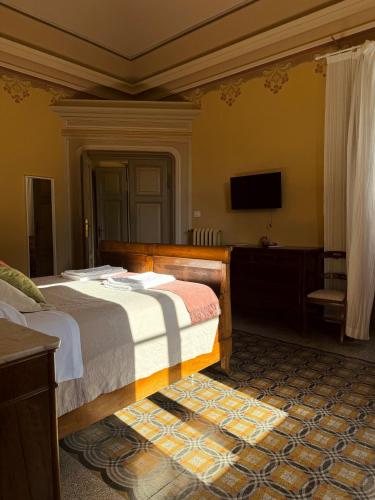 a bedroom with a bed and a flat screen tv at Palazzo Lucangeli in Porto Recanati