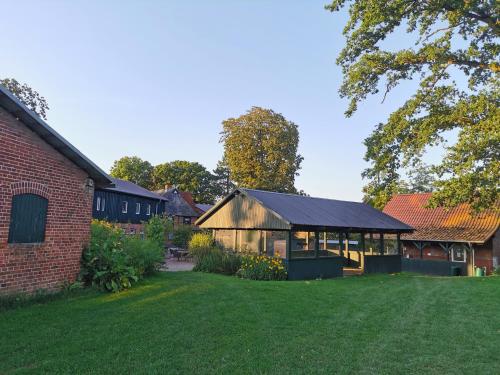 a barn conversion with a garden and a house at Outdoor Lounge mit Seeblick in Belau