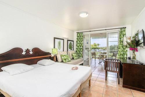 a bedroom with a bed and a table and chairs at Village Sainte Luce, Martinique - maeva Home - Studio 3 personnes - Sélection MAE-0664 in Sainte-Luce