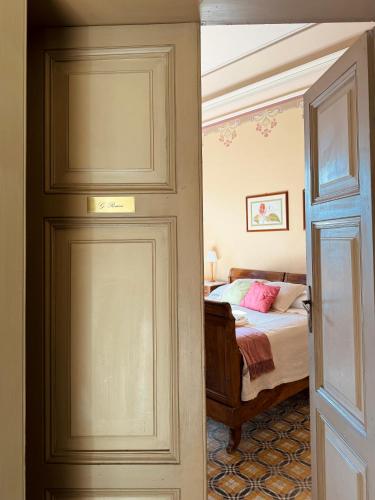 a door leading to a bedroom with a bed at Palazzo Lucangeli in Porto Recanati