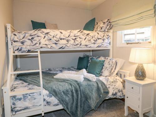 a bedroom with two bunk beds and a bed at The Lodge at Wildersley Farm in Belper
