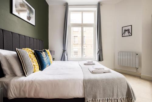 a bedroom with a large bed and a window at The Whitecross Street Collection in London