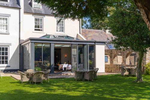an extension of a house with a table and chairs at 61 Durham in Durham