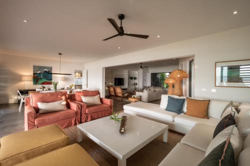 a living room with couches and a dining room at Villa Rubis by muse villas in Belle Mare