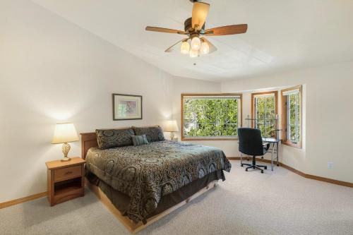 a bedroom with a bed and a ceiling fan at Portland Park Townhome Unit 1 in Ouray