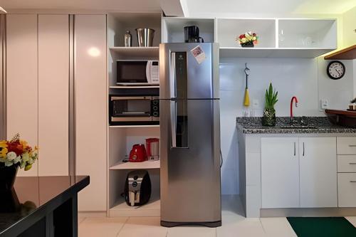 a kitchen with a stainless steel refrigerator at Estada Inesquecível 17 Guarapari in Guarapari