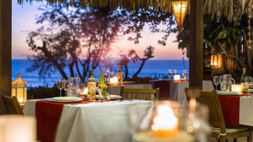 a table with a white table cloth and candles on it at Pousada Jeribá in Jericoacoara