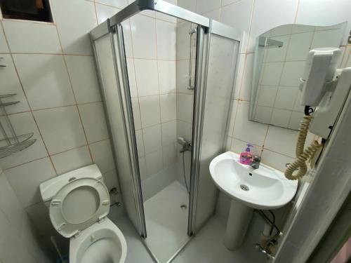 a bathroom with a shower and a toilet and a sink at Camel Hotel & Apart in Antalya