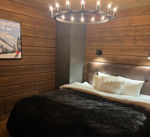 a bedroom with a bed and a chandelier at Fantastic Mountain Cabin with Sauna in Idre in Idre