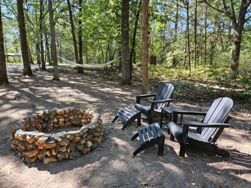 two benches and a fire pit in a park at Bennettscape Tiny Cabin in Lebanon