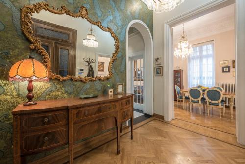 a room with a dresser and a mirror on a wall at Rare Luxury Gem in the Most Elite Area near Syntagma Square in Athens