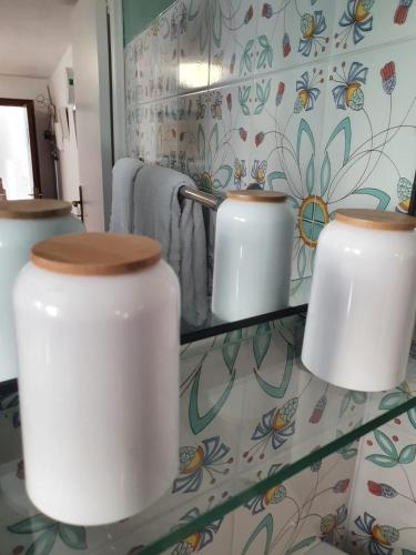 a bathroom with three toilets on a glass shelf at Casa della Frutta in Anacapri