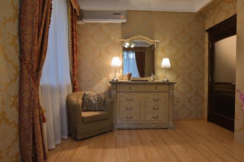 モスクワにあるLakshmi Apartment Boulevard 3-Bedroomのベッドルーム(ドレッサー、椅子、鏡付)