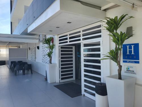 a lobby of a building with a door and a plant at Hotel Natursun in Torremolinos