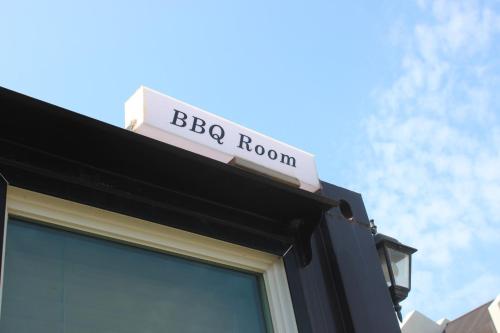 a sign on top of a building with a bbq room at Jeju Sorang in Farms Village in Jeju