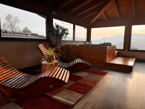 a living room with two chairs and a soak at Albergo Canella in Fuipiano Valle Imagna