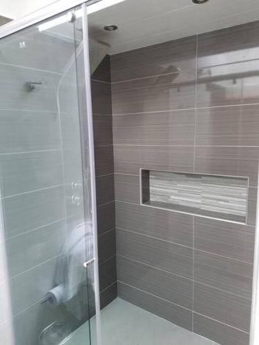 a shower with a glass door in a bathroom at Spain style country house in Cajica in Cajicá