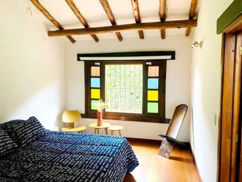 a bedroom with a bed and a window at Spain style country house in Cajica in Cajicá