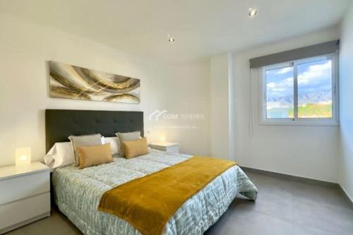 a bedroom with a large bed and a window at Penthouse Apartment Las Americas in Playa de las Americas