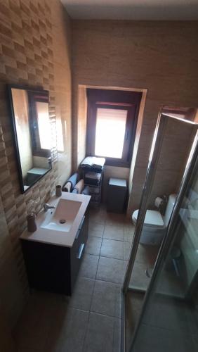 a bathroom with two sinks and a mirror at Casa Alicia in Poio