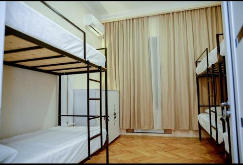 a bedroom with two bunk beds and a window at EUPHORIA Mariam in Tbilisi City