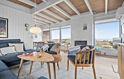 a living room with a couch and a table at Holiday Home Kløverbakken in Slagelse
