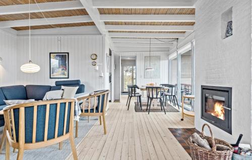 a living room with a couch and a fireplace at Holiday Home Kløverbakken in Slagelse