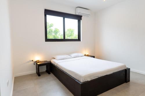a bedroom with a bed and a window at Casa Familia in Grote Berg