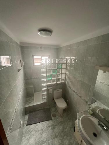 a bathroom with a toilet and a sink at Casa Pedro in Costa Teguise